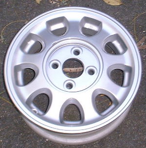 91-93 NISSAN NX 13x5 Oval 9 Hole with Covered Lugs SILVER